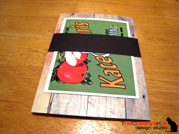 The back of the closed invitation, with the RSVP postcard and reception card tucked into the belly band.